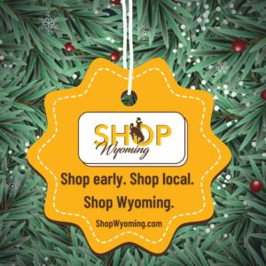 Yellow Christmas Ornament on a tree that has the Shop Wyoming logo and says "Shop early. Shop local. Shop Wyoming. shopwyoming.com"